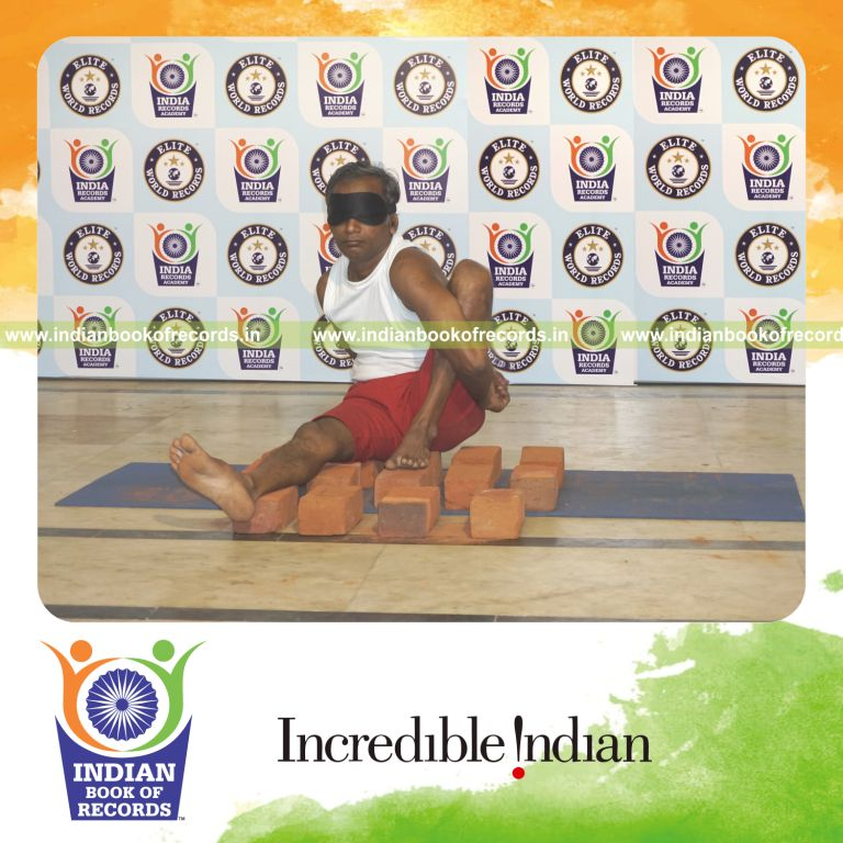 individual performing maximum yogasanas blindfolded on bricks in 15 minutes for record in Indian Book of Records