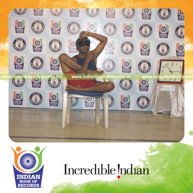 individual performing maximum yogasanas blindfolded on a chair in 10 minutes for record in Indian Book of Records
