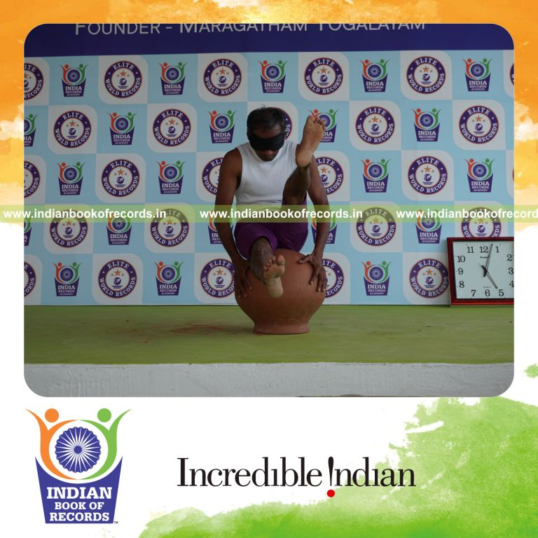 individual performing maximum yogasanas blindfolded on an inverted pot in 5 minutes for record in Indian Book of Records
