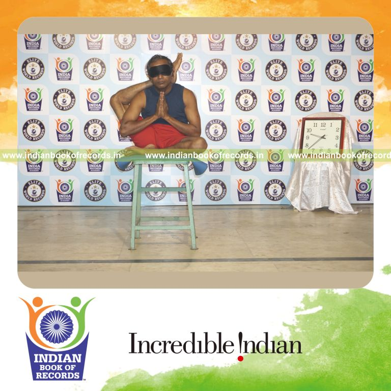 individual performing maximum yogasanas blindfolded on a stool in 10 minutes for record in Indian Book of Records