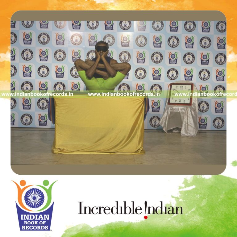 individual performing maximum yogasanas blindfolded on a table in 10 minutes for record in Indian Book of Records