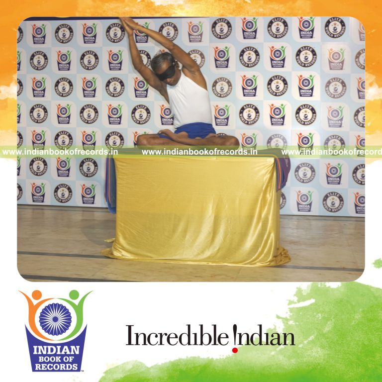 individual performing maximum yogasanas blindfolded on a table in 15 minutes for record in Indian Book of Records