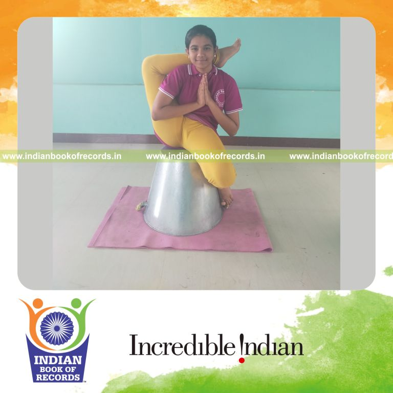 individual minor female performing maximum yogasanas on an inverted bucket in 10 minutes for record in Indian Book of Records