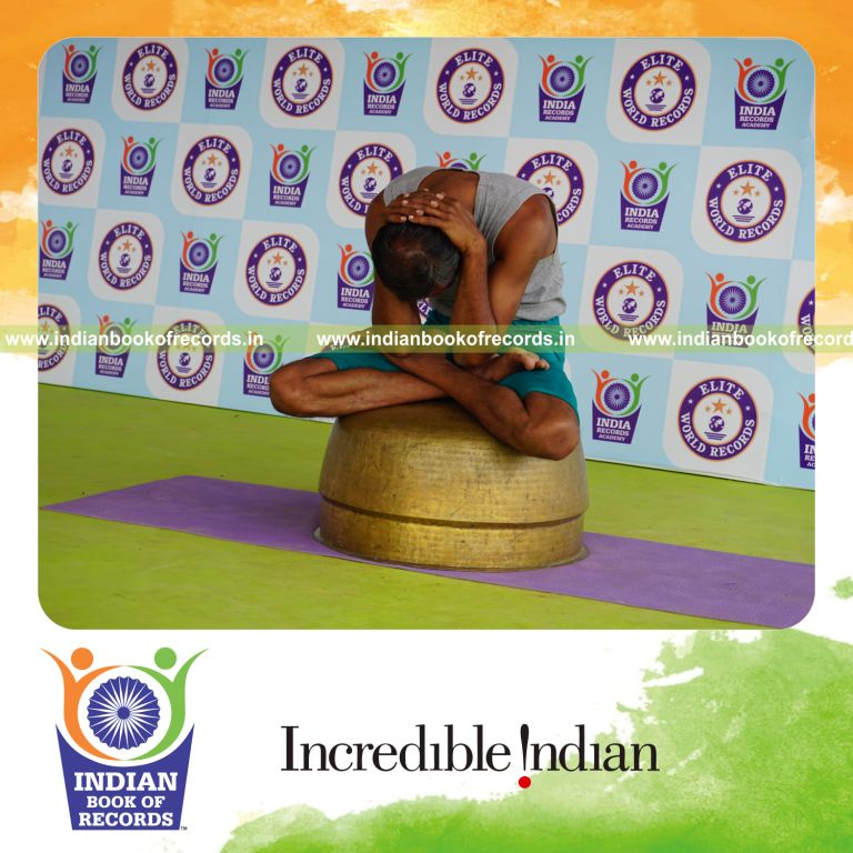 individual performing maximum yogasanas on an inverted vessel in 10 minutes for record in Indian Book of Records