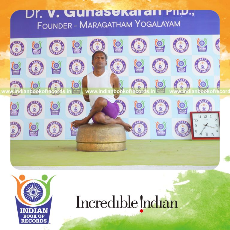individual performing maximum yogasanas on an inverted vessel in 5 minutes for record in Indian Book of Records