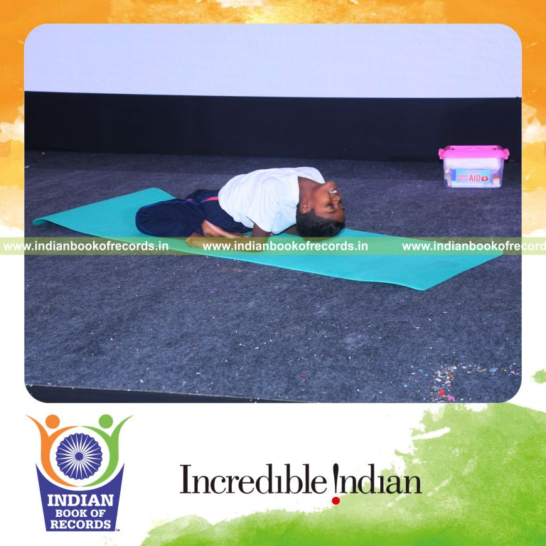individual minor male performing maximum yogasanas in 5 minutes for record in Indian Book of Records