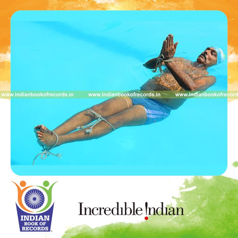 male individual performing yogasanas in water within thirty minutes for record in Indian Book of Records