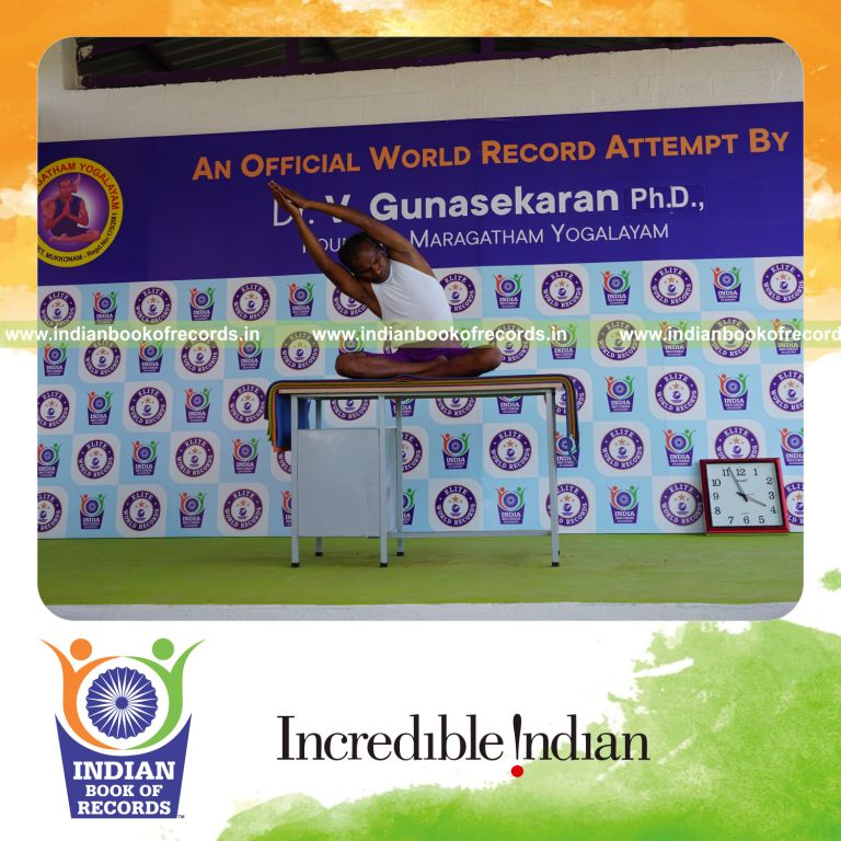 individual performing maximum yogasanas on a table in 5 minutes for record in Indian Book of Records