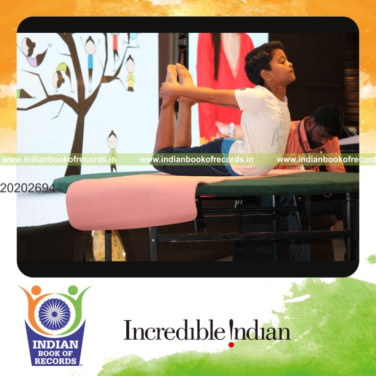 individual minor male performing maximum yogasanas on a table in 5 minutes for record in Indian Book of Records