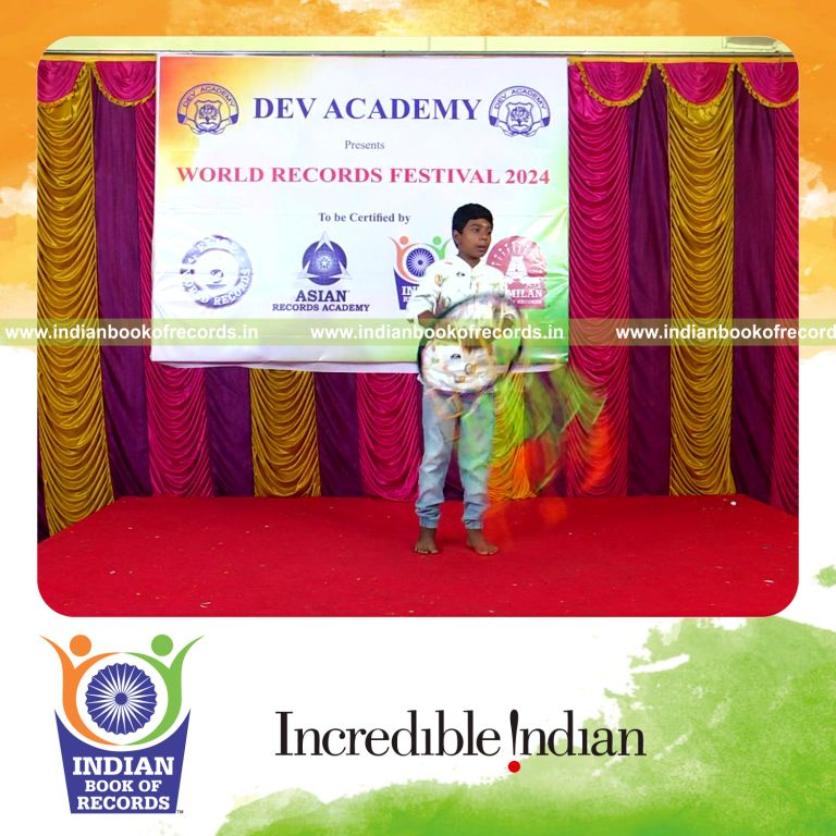 Individual solving mental arithmetic addition problems while performing Silambam with a ring ball simultaneously for Indian Book of Records