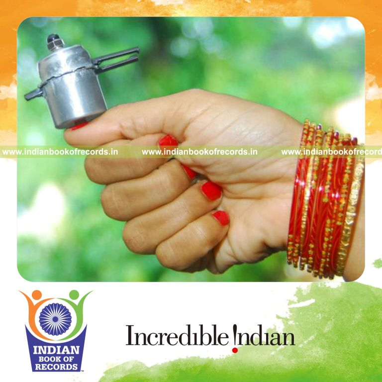 female creator presenting miniature pressure cooker model for Indian Book of Records
