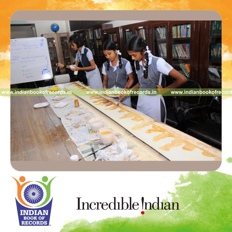 minor female creating long monochromatic painting for Indian Book of Records