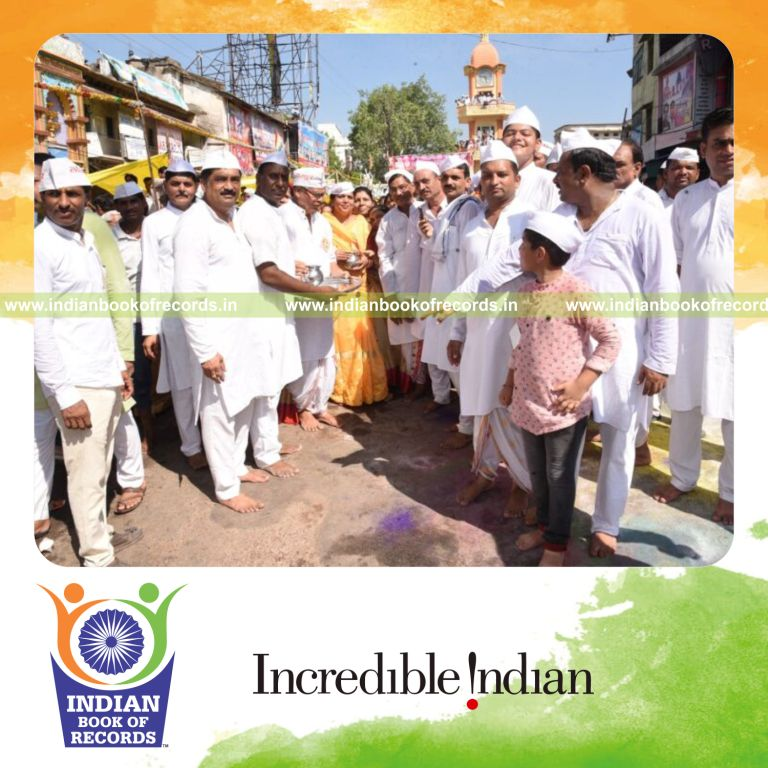 Crowd gathered wearing Indian Nehru caps in a large coordinated event recognized by Indian Book of Records