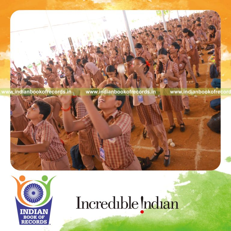 Participants playing catch using origami balls simultaneously in a large group setting for Indian Book of Records