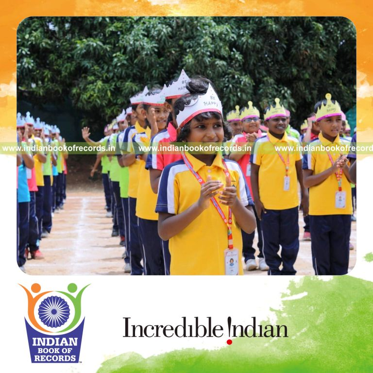 A large group wearing paper crowns together at a single venue for the Indian Book of Records
