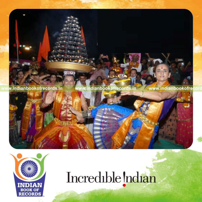 Large group performing Sheri Garba dance while balancing pots on their heads recognized by Indian Book of Records