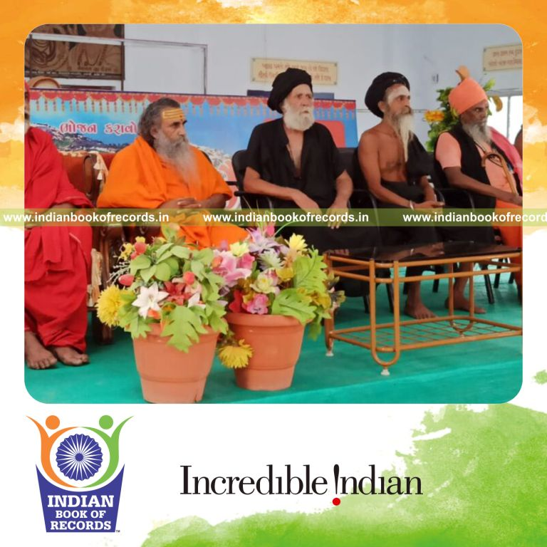 Individual holding a headstand pose in cross-legged padmasana position indoors for an extended duration recognized by Indian Book of Records