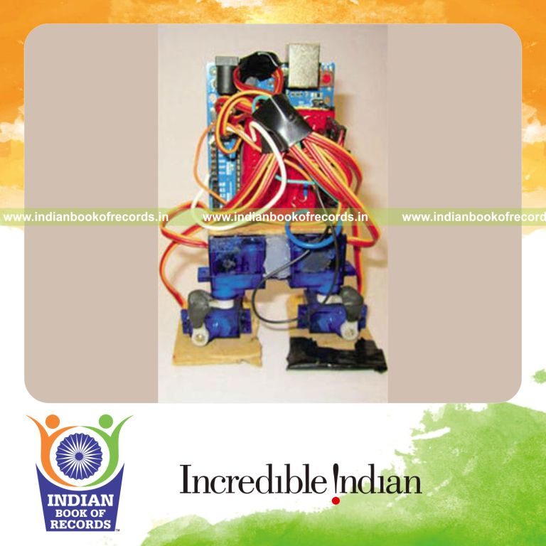 male individual creating smallest bipedal robot for record in Indian Book of Records