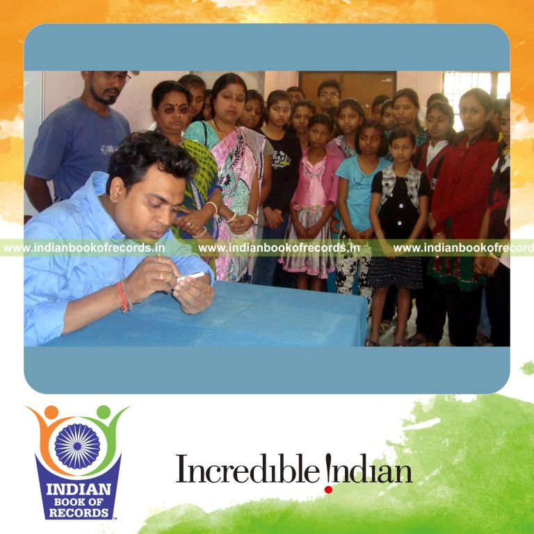 male individual creating a very small chalk idol for record in Indian Book of Records