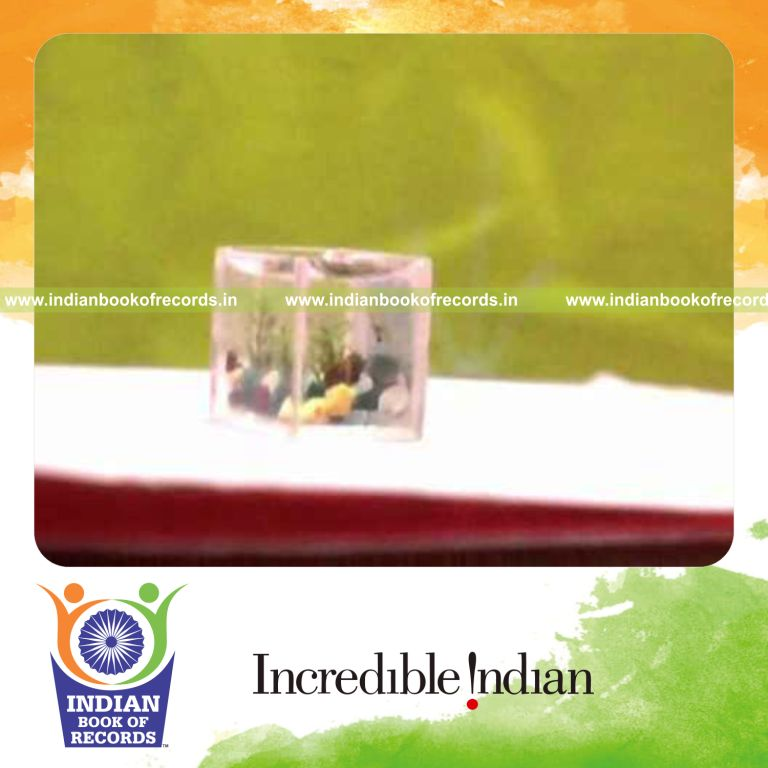male individual creating smallest fish tank for record in Indian Book of Records