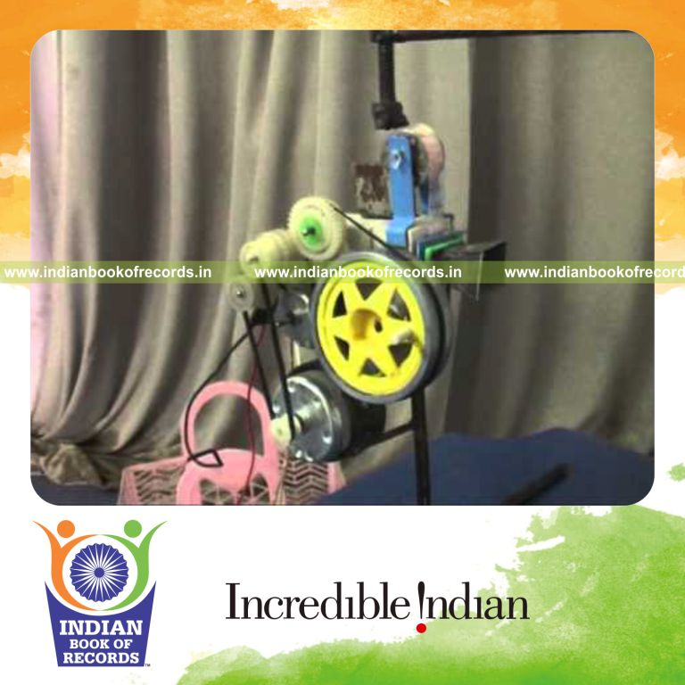 male individual creating smallest functional cine reel projector for record in Indian Book of Records