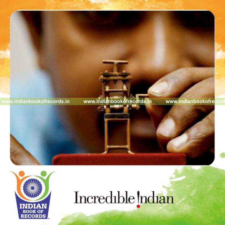 male individual creating smallest gold rolling machine for record in Indian Book of Records
