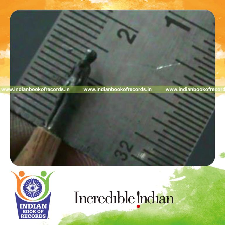 microscopic sculpture of man and woman carved from pencil lead for record in Indian Book of Records