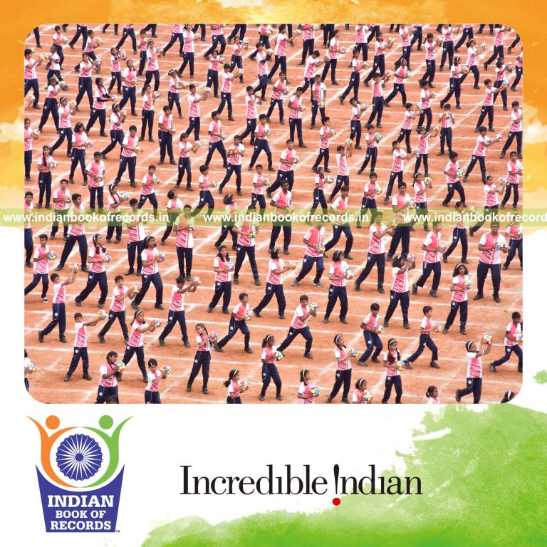 Participants performing a coordinated sports drill while holding balls at one venue for Indian Book of Records