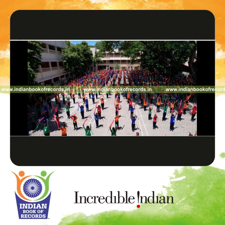 Large group executing sports drill routines while holding balloons together for Indian Book of Records