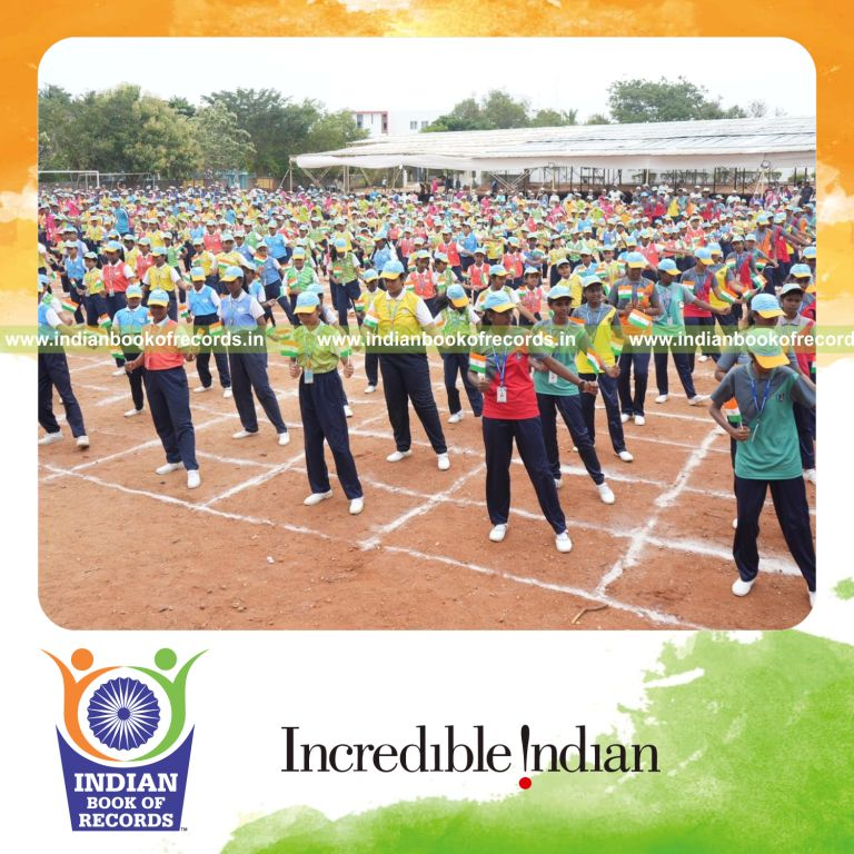 Participants performing coordinated sports drills while holding flags simultaneously for Indian Book of Records