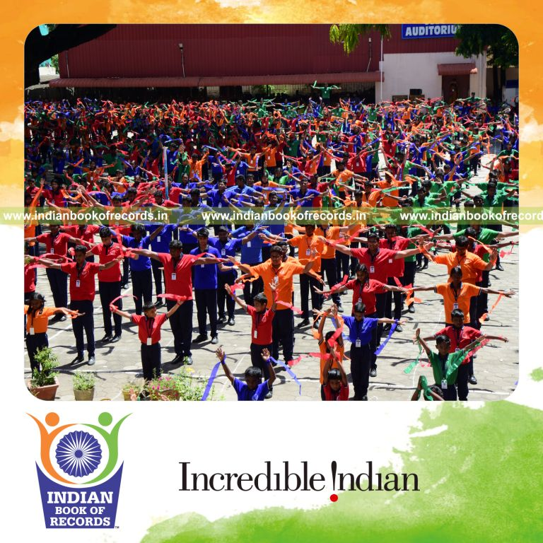 Participants performing coordinated sports drills while holding ribbons simultaneously at one venue for Indian Book of Records