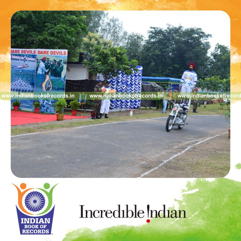 individual standing on motorcycle while riding for longest time for Indian Book of Records