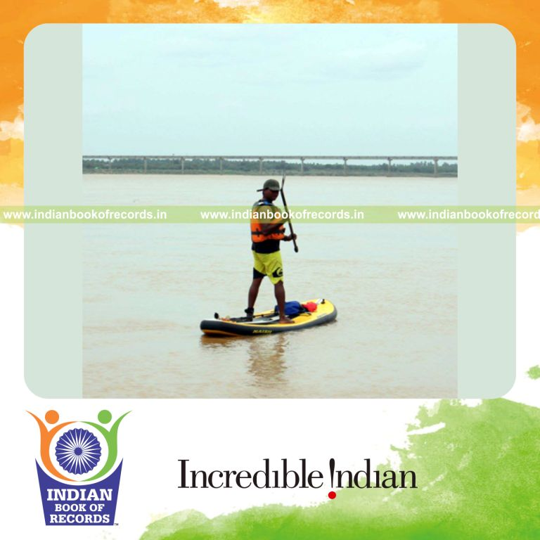 individual performing standup paddling across water bodies for Indian Book of Records