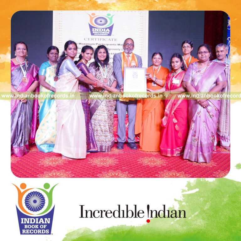 Group simultaneously folding paper into origami hearts in a coordinated activity for Indian Book of Records