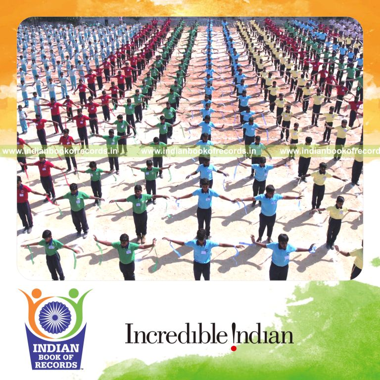 Participants performing a coordinated sports drill while holding ribbons at one location recognized by Indian Book of Records