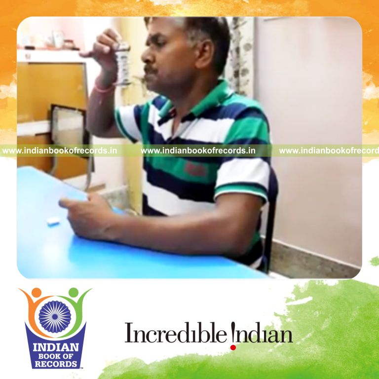 individual stacking starburst tower on spoon held in mouth for record in Indian Book of Records