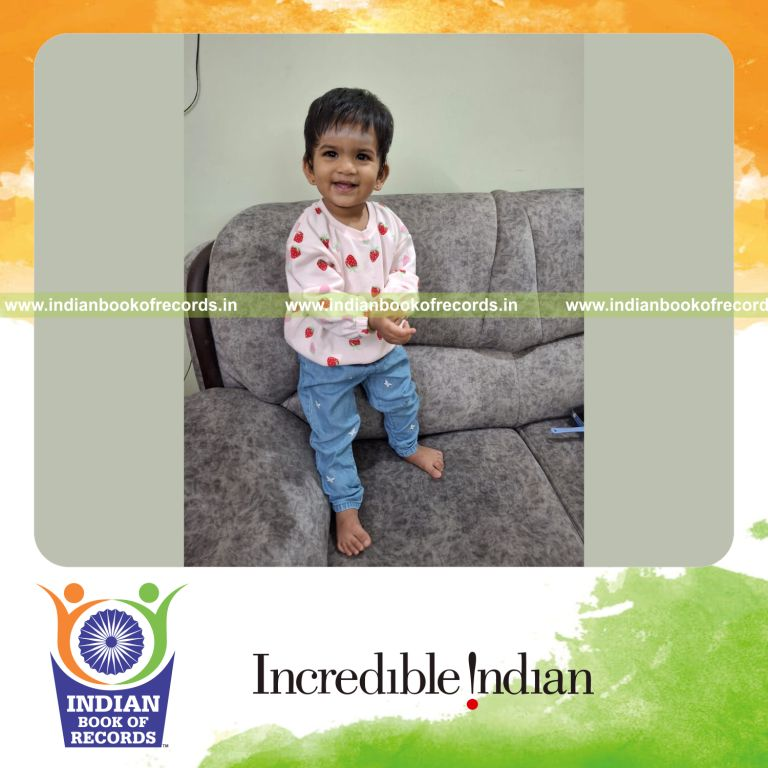 Toddler lifting a 3 kg dumbbell demonstrating strength recognized by Indian Book of Records