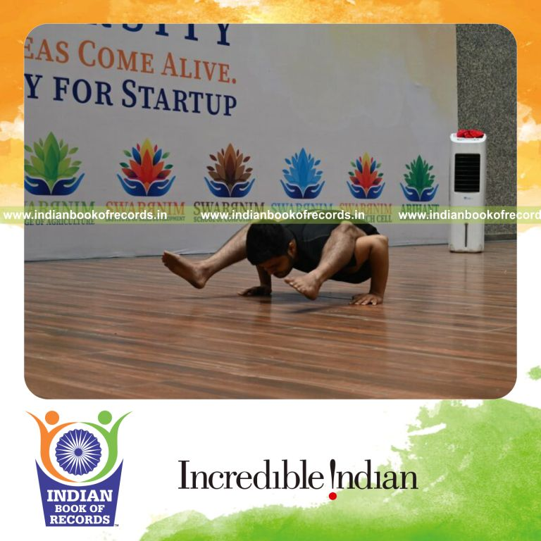 Young boy performing wing push-ups in firefly yoga pose with balance and strength recognized by Indian Book of Records