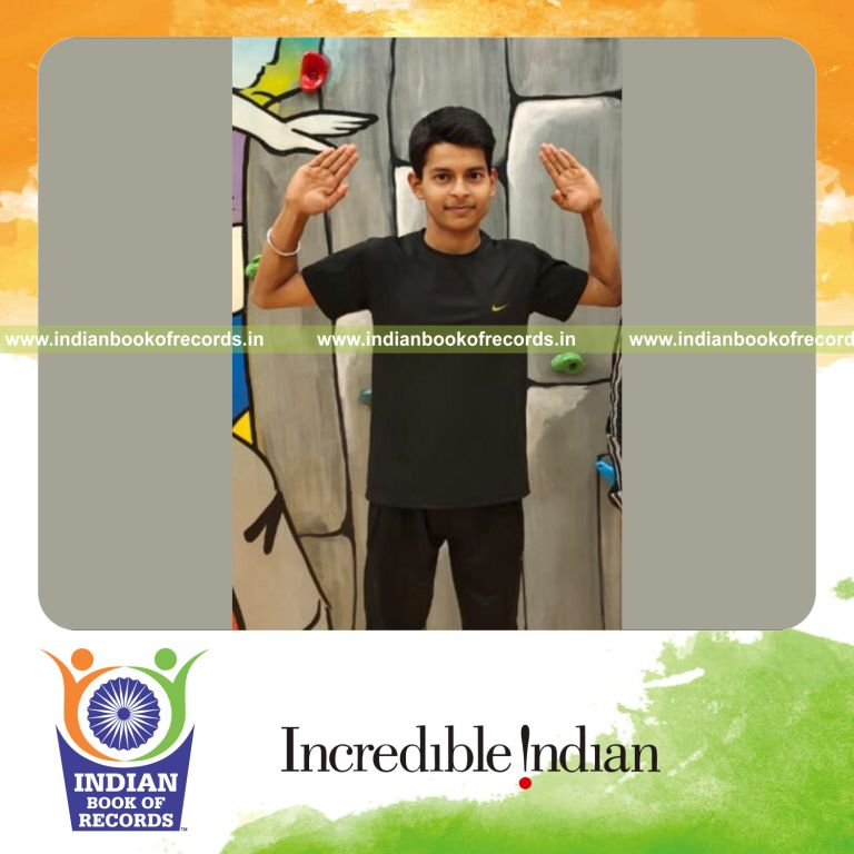 Young boy performing rapid jumping jacks in a timed activity recognized by Indian Book of Records