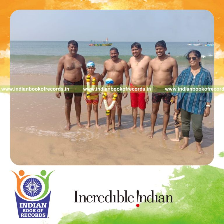 Young boy swimming under the sea during low tide as part of a record attempt recognized by Indian Book of Records